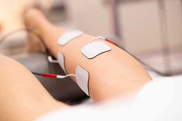 Electro Stimulation In Physical Therapy To A Young Woman